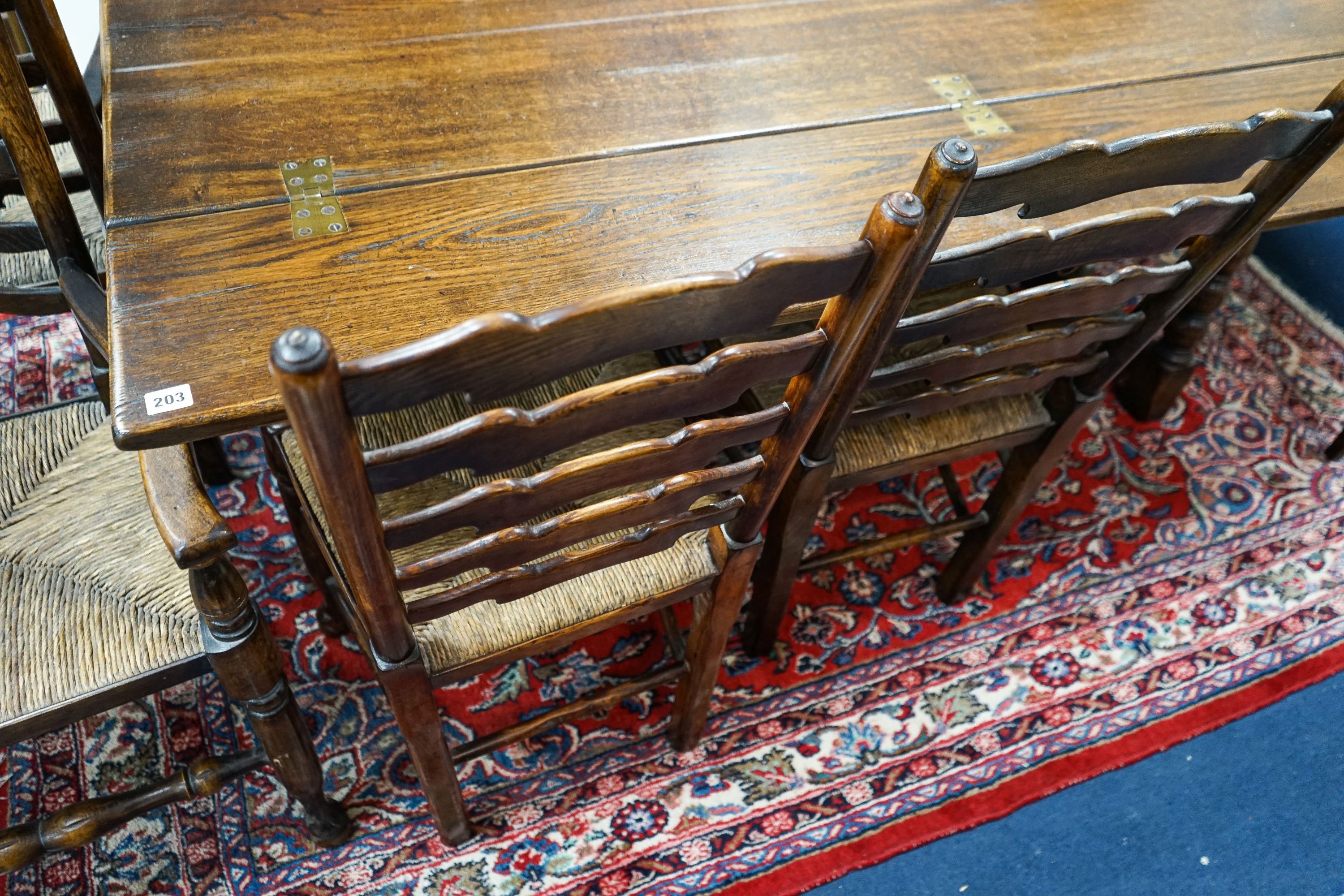 A set of eight Titchmarsh & Godwin elm and beech ladderback rush seat chairs, two with arms